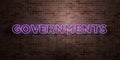 GOVERNMENTS - fluorescent Neon tube Sign on brickwork - Front view - 3D rendered royalty free stock picture