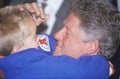 Governor Bill Clinton embraces a child at a Denver campaign rally in 1992 on his final day of campaigning in Denver, Colorado