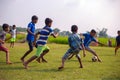 Children playing football on the field. School going kids playing soccer game to compete and win school league