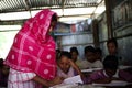 Community school teacher teaching in the class practically with notebook and pen