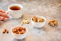 Gozinaki bars Georgian Christmas confection made of sunflower seeds and honey. Peanuts in sugar in white bowl and on gray Royalty Free Stock Photo