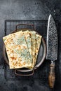 Gozleme Turkish flatbread with greens and cheese. Black background. Top view