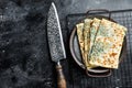 Gozleme Turkish flatbread with greens and cheese. Black background. Top view. Copy space