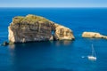 Gozo, Malta - Amazing Fungus Rock at Dwejra bay with sailboat Royalty Free Stock Photo