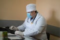 GP doctor working with computer in medical office. Male general practitioner medic sitting at desk and typing on Royalty Free Stock Photo