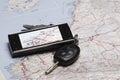 A GPS and the car keys on a map.