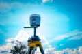 GPS surveying instrument on blue sky