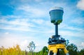 GPS surveying instrument on blue sky and rice field Royalty Free Stock Photo