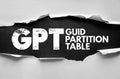 GPT GUID Partition Table text in cracked bold font behind torn paper. Conceptual image symbolizing computer storage, hard disk Royalty Free Stock Photo