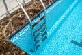 Grab bars ladder in the blue swimming pool Royalty Free Stock Photo