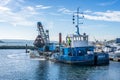 Grab Dredger C H Horn at work dredging Poole Harbour marina in Dorset, UK