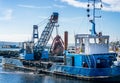 Grab Dredger C H Horn at work dredging Poole Harbour marina in Dorset, UK Royalty Free Stock Photo