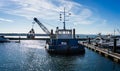 Grab Dredger C H Horn at work dredging Poole Harbour marina in Dorset, UK