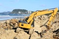 Grab excavator. Boulder wall construction.