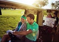 Grab your friends for a day on the fairway. a group of friends riding in a golf cart on a golf course.