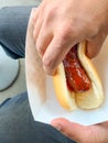 Man grabbing street food bratwurst