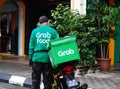 GrabFood Delivery Rider Standing Beside His Bike