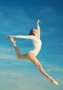 Grace and beauty. Classic dance style. Young ballerina jumping on blue sky. Cute ballet dancer. Pretty woman in dance Royalty Free Stock Photo
