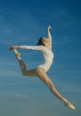Grace and beauty. Classic dance style. Young ballerina jumping on blue sky. Cute ballet dancer. Pretty woman in dance Royalty Free Stock Photo