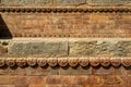 Graceful ancient stone carving. Brown stone texture. Wall of an old Hindu temple at Durbar Square in Kathmandu, Nepal Royalty Free Stock Photo