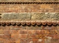 Graceful ancient stone carving. Brown stone texture. Wall of an old Hindu temple at Durbar Square in Kathmandu, Nepal Royalty Free Stock Photo