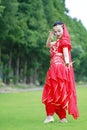 Graceful Asian Chinese belly dancer dancing on grass Royalty Free Stock Photo