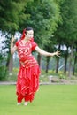 Graceful Asian Chinese belly dancer dancing on grass Royalty Free Stock Photo