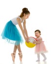 Graceful Ballerina Playing Ball with Adorable Smiling Toddler Girl. Royalty Free Stock Photo