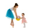 Graceful Ballerina Playing Ball with Adorable Smiling Toddler Girl. Royalty Free Stock Photo