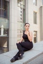 Graceful ballerina sitting on the balusters