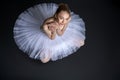 Graceful ballerina sitting on the floor Royalty Free Stock Photo