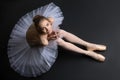 Graceful ballerina sitting on the floor Royalty Free Stock Photo