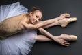 Graceful ballerina sitting on the floor Royalty Free Stock Photo