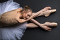 Graceful ballerina sitting on the floor Royalty Free Stock Photo