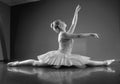 Graceful ballerina sitting with legs stretched out