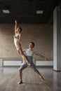 Graceful ballerina training with her partner performing dancing elements