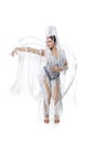 Beautiful young woman in carnival, stylish masquerade costume with feathers dancing on white studio background. Concept Royalty Free Stock Photo