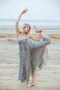 Graceful beautiful young woman dancer on the beach Royalty Free Stock Photo