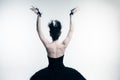 Back view of young ballerina wearing black tutu, stage dress posing  on white studio backgorund Royalty Free Stock Photo