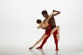 Young graceful couple of ballet dancers dancing on white studio background Royalty Free Stock Photo