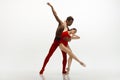 Young graceful couple of ballet dancers dancing on white studio background Royalty Free Stock Photo