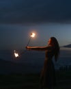 Graceful elegant red haired female fireshow performer