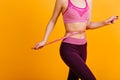 Graceful european girl posing with measure tape on her waist. Photo of fit woman on diet