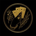 Graceful female hand of a gypsy woman holds tarot cards. Round gold icon on a black background. The concept of Royalty Free Stock Photo