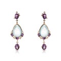 Graceful golden earrings with diamonds, amethysts and mother of pearl Royalty Free Stock Photo