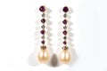 Long gold earrings with diamonds, rubies and pearls, on a white background Royalty Free Stock Photo