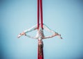 Graceful gymnast performing aerial exercise