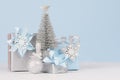 Graceful home decor for christmas celebration - pastel blue and metallic gift boxes with silver christmas tree, shiny ball. Royalty Free Stock Photo