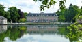 Benrath pink palace and green trees are reflected on the mirror-like surface of the lake, Dusseldorf, Germany. Royalty Free Stock Photo