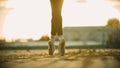 Graceful legs of young woman ballerina standing on the roof on her tiptoes - sunset Royalty Free Stock Photo